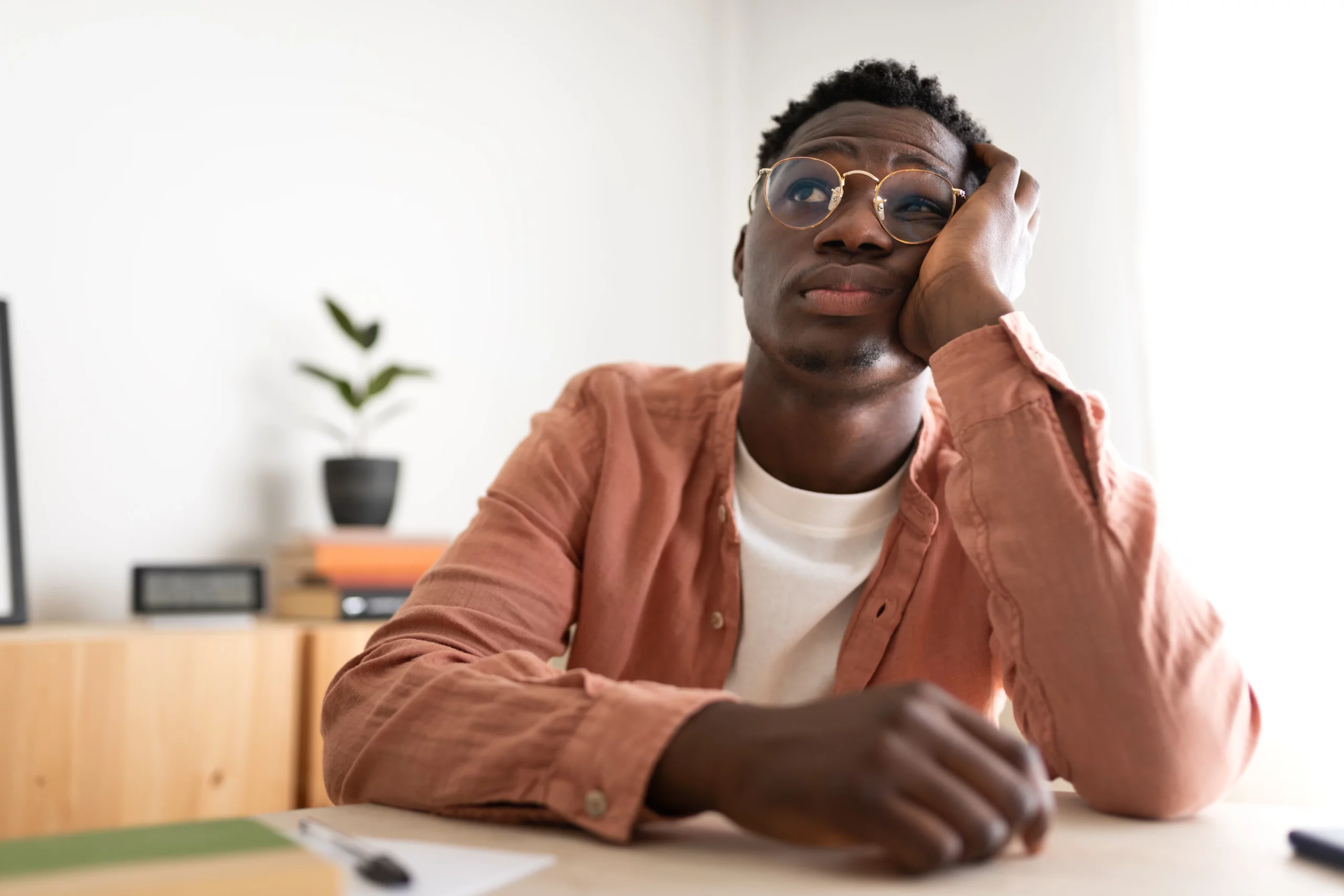 Man in glasses looking stressed and uncertain, representing concerns about how long it takes to receive a bankruptcy discharge in Florida after filing for bankruptcy relief.