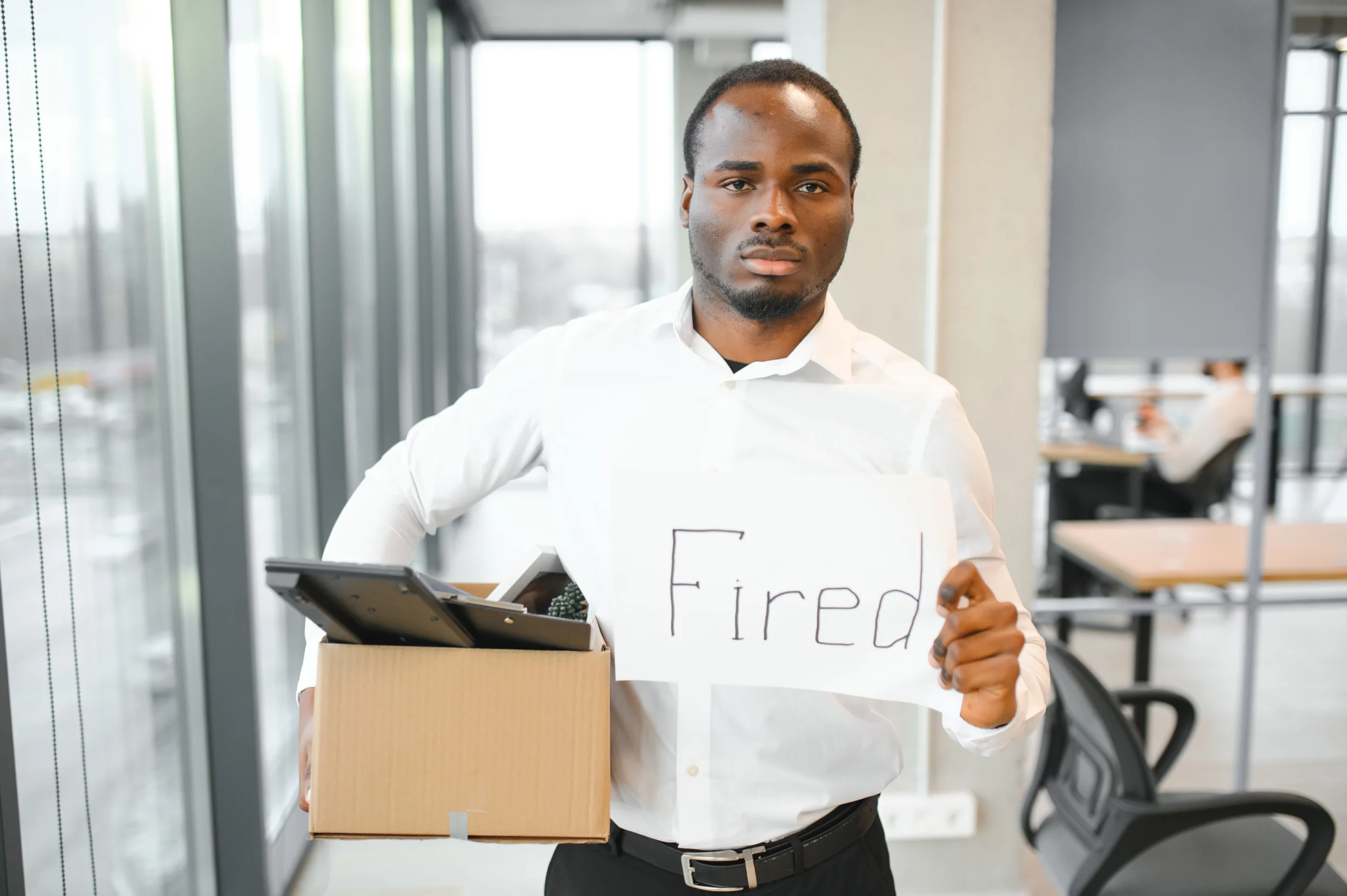 Employee carrying a box after losing a job, illustrating legal protections against being fired for filing bankruptcy under Florida employment and bankruptcy laws.